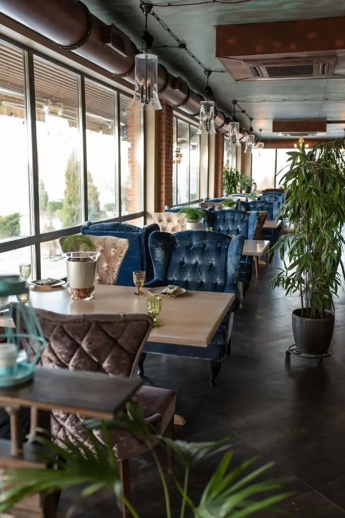 beautiful-interior-restaurant-semiantique-dark-brown-shades-served-tables.webp